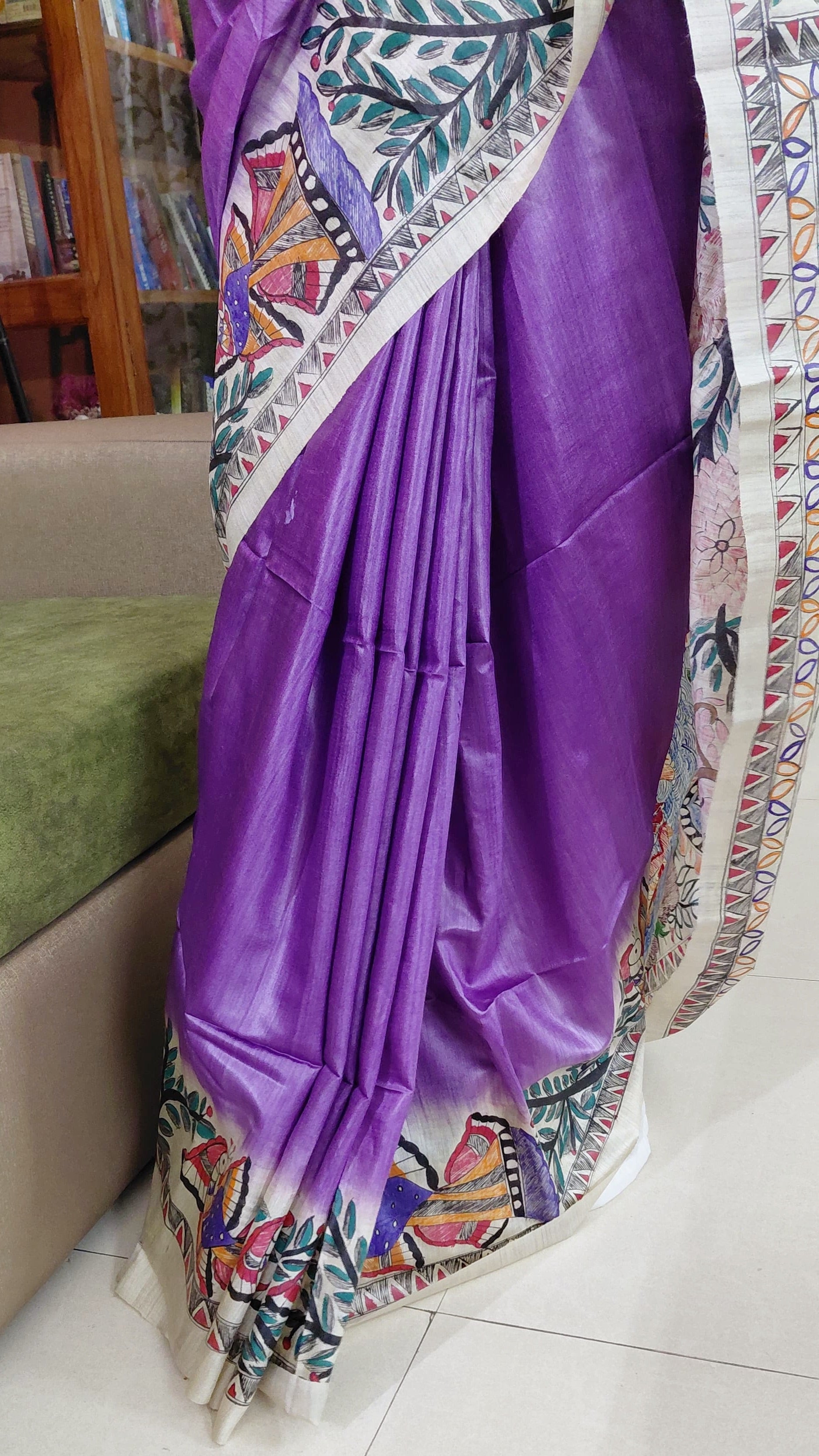 Close-up of Madhubani fish and floral border detailing