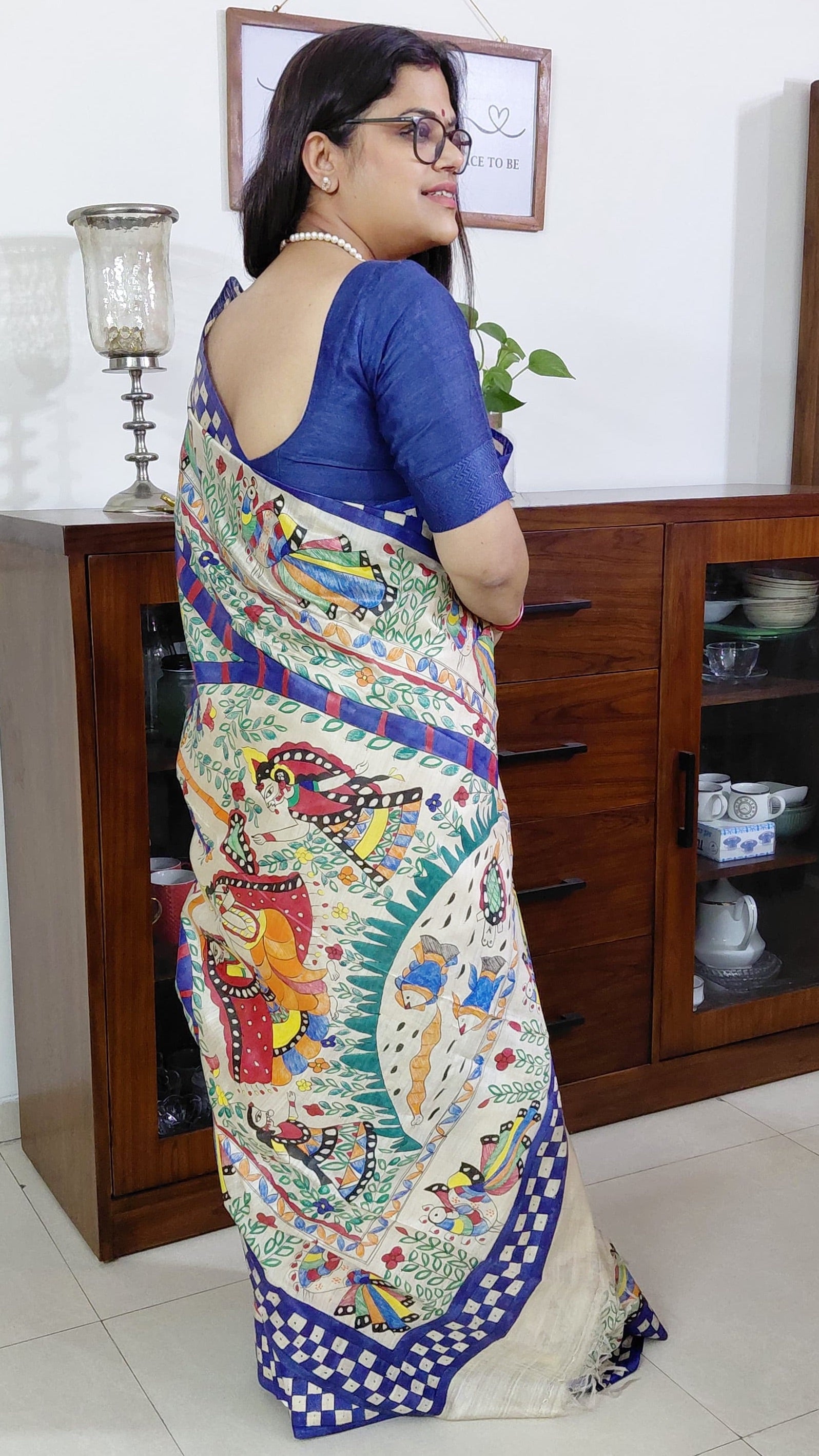 Close-up of peacock and folk dancer border design