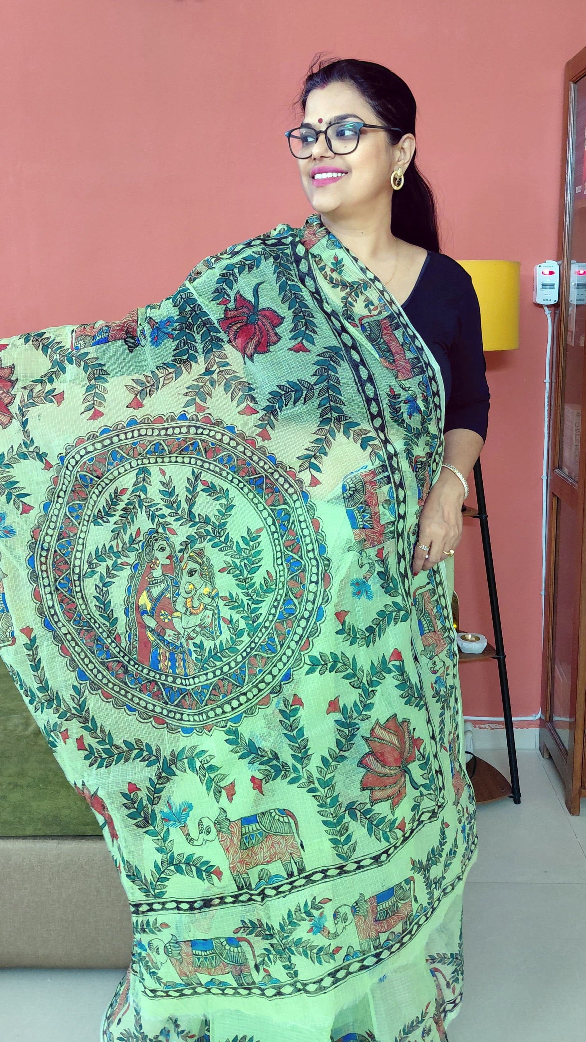 Detailed Madhubani pallu with divine mother and child artwork