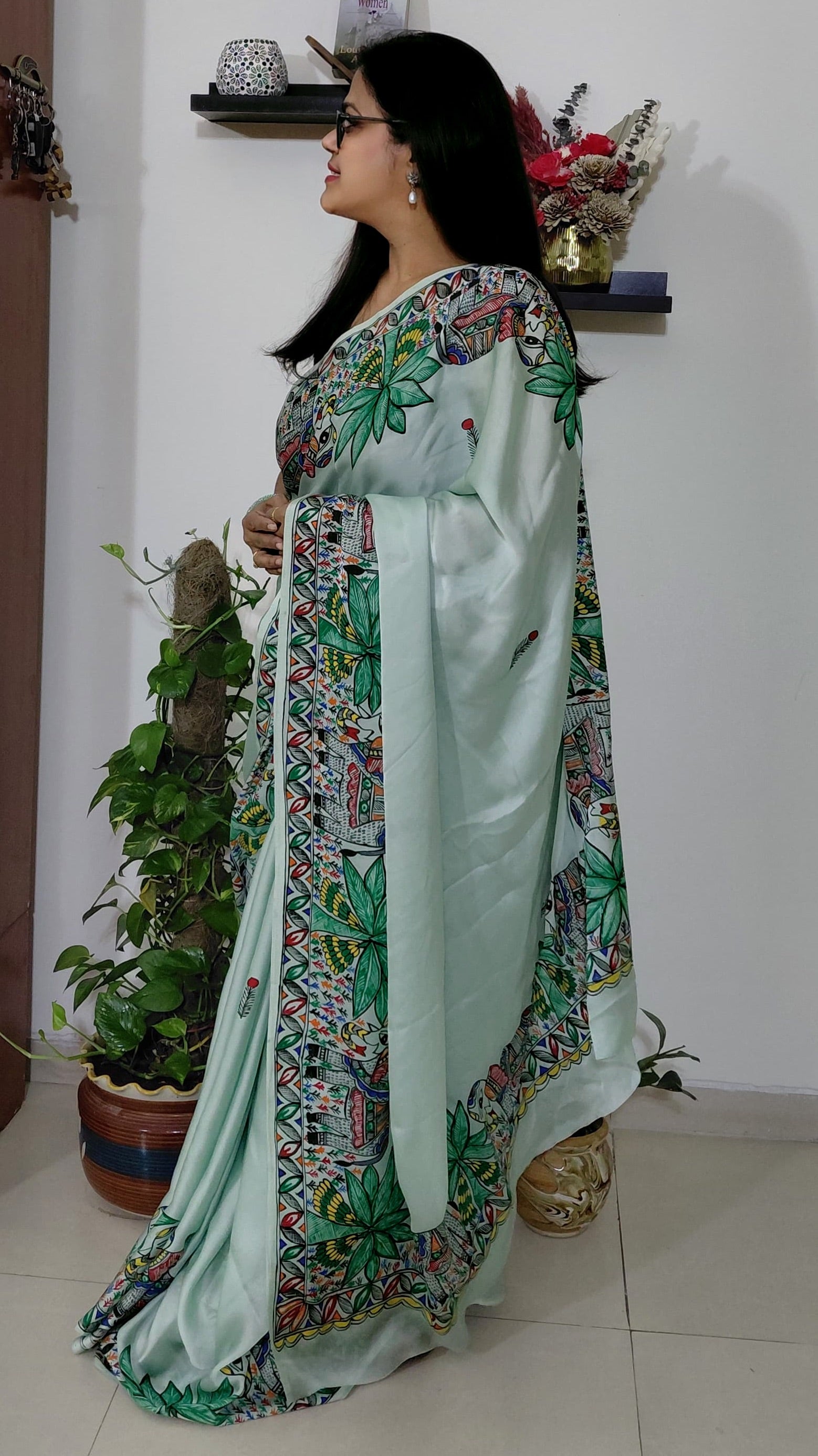 Side pose showing floral and geometric Madhubani artwork