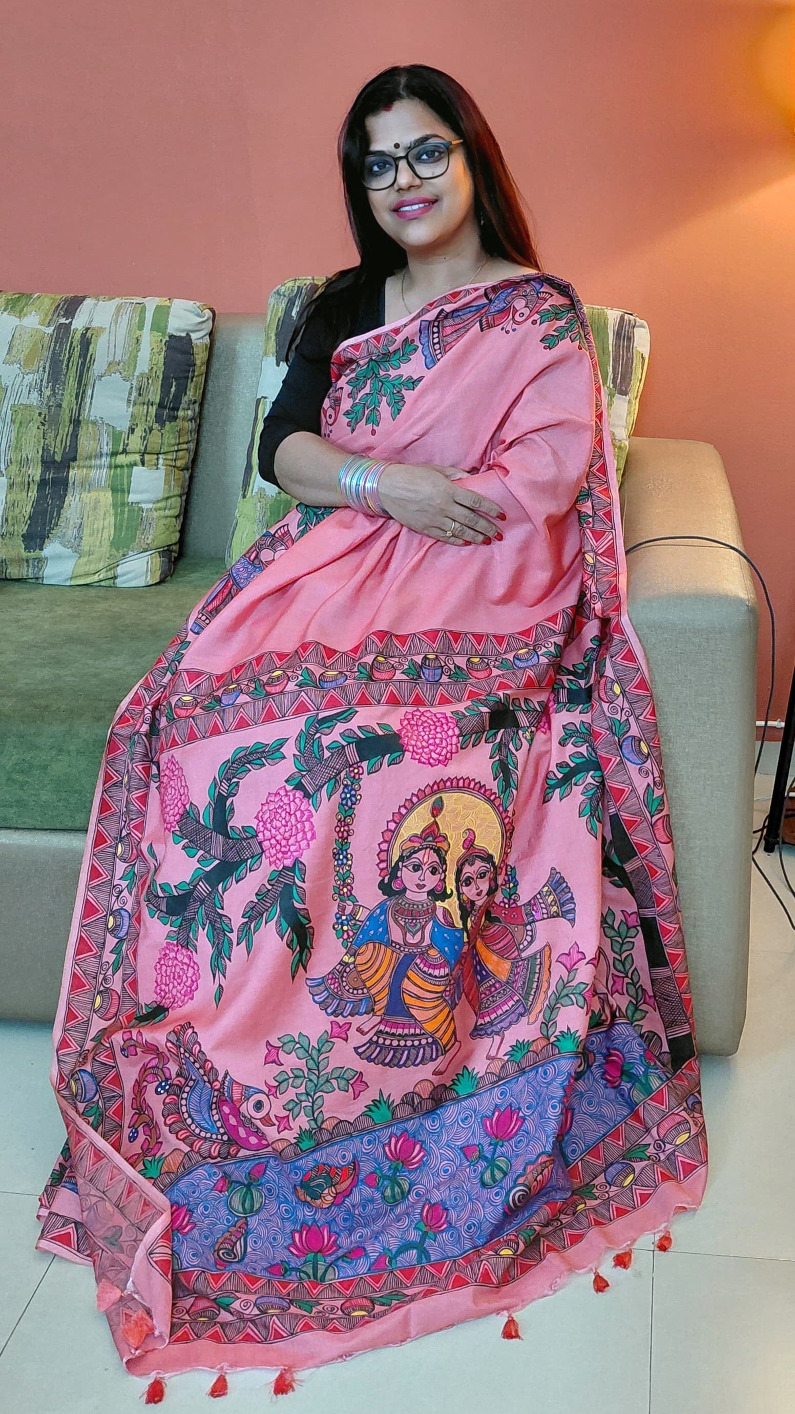 Full saree display showing Radha Krishna Madhubani artwork on blush pink silk