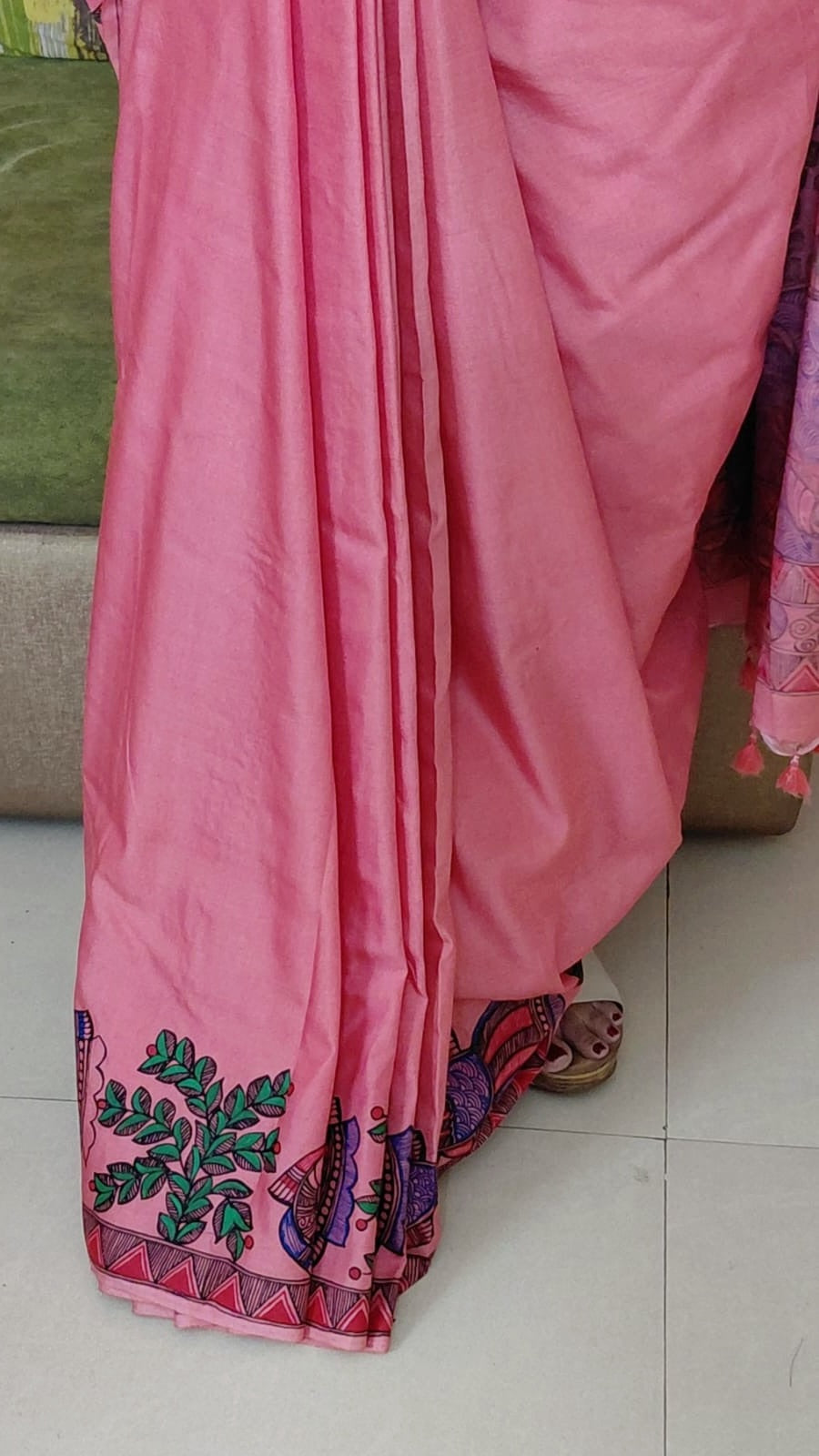 Close-up of blush pink Katan silk saree pleats with Madhubani border detailing