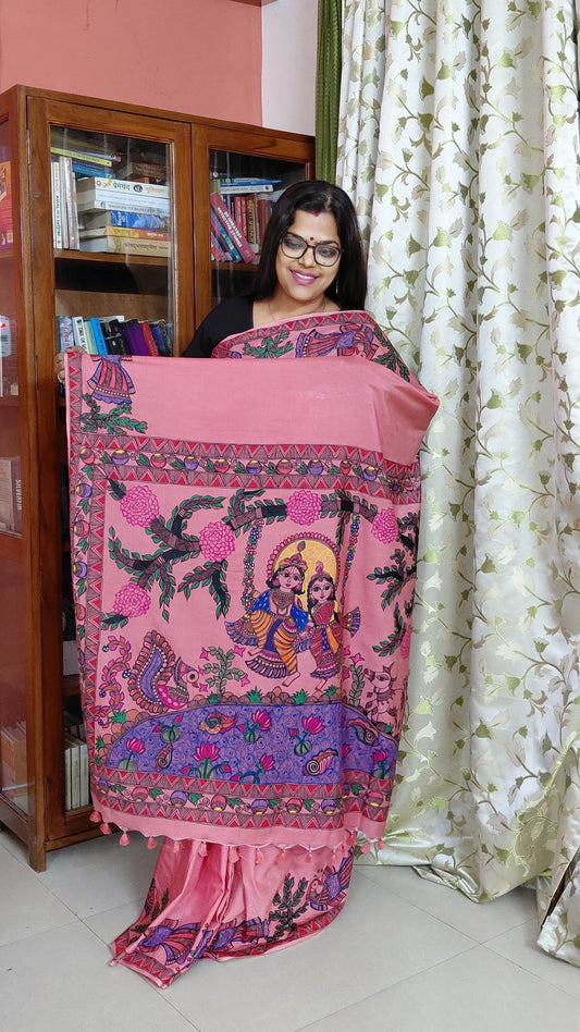 Woman wearing blush pink Katan silk Madhubani saree with Radha Krishna pallu artwork