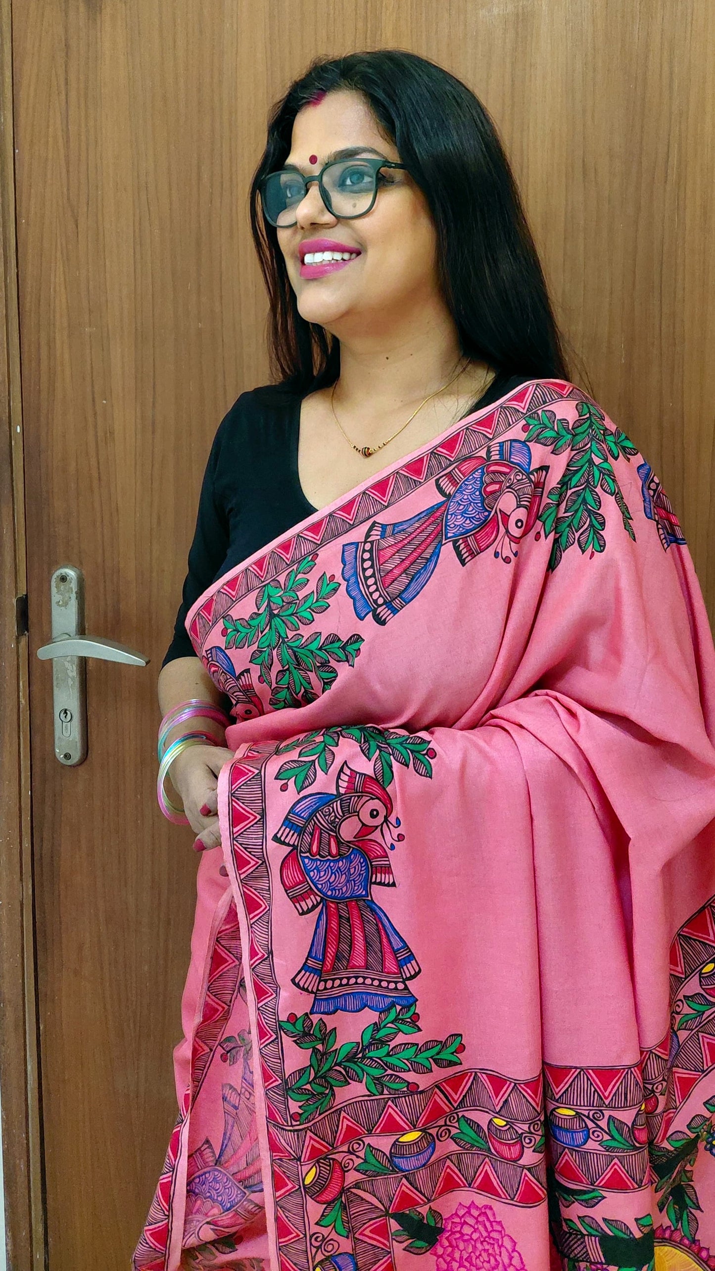 Portrait shot of model wearing blush pink Katan silk Madhubani saree