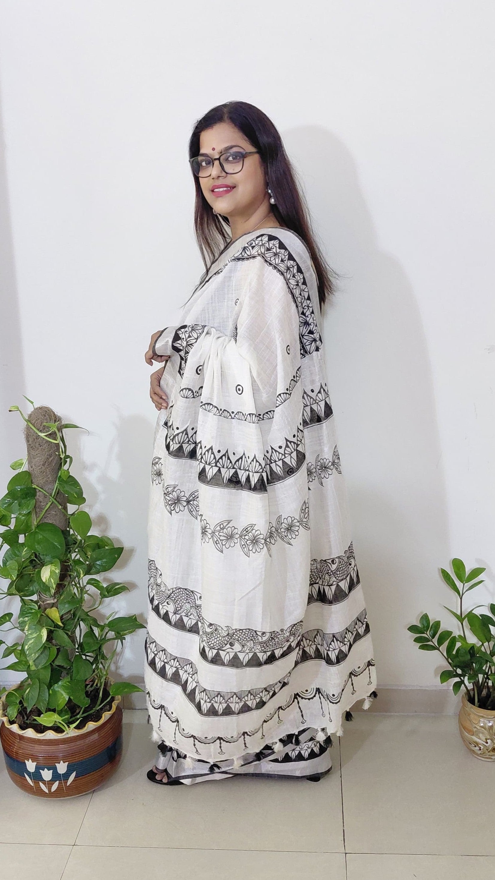 Model wearing Madhubani saree with fish motif border