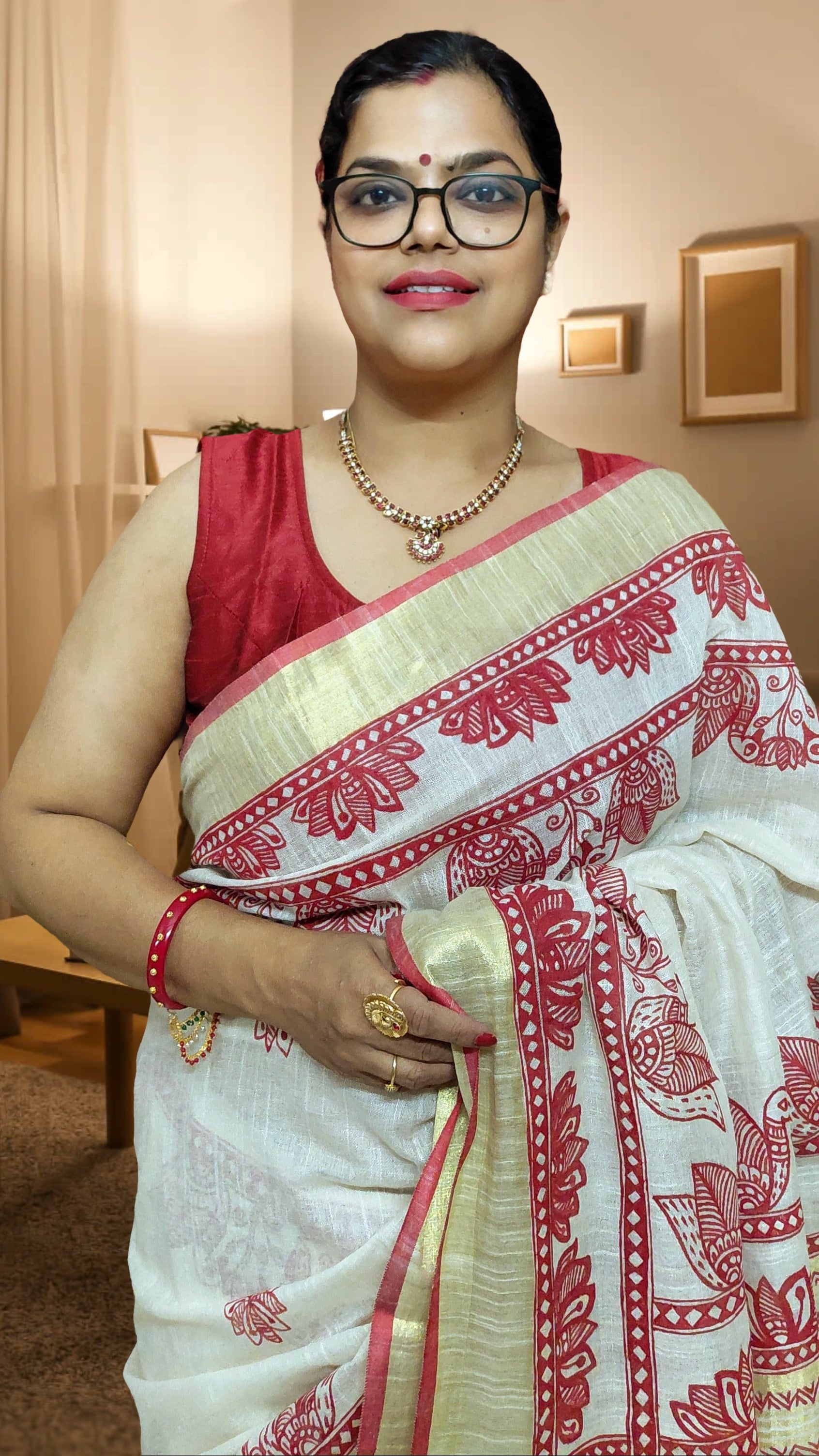 Linen saree featuring crimson bird and floral artwork