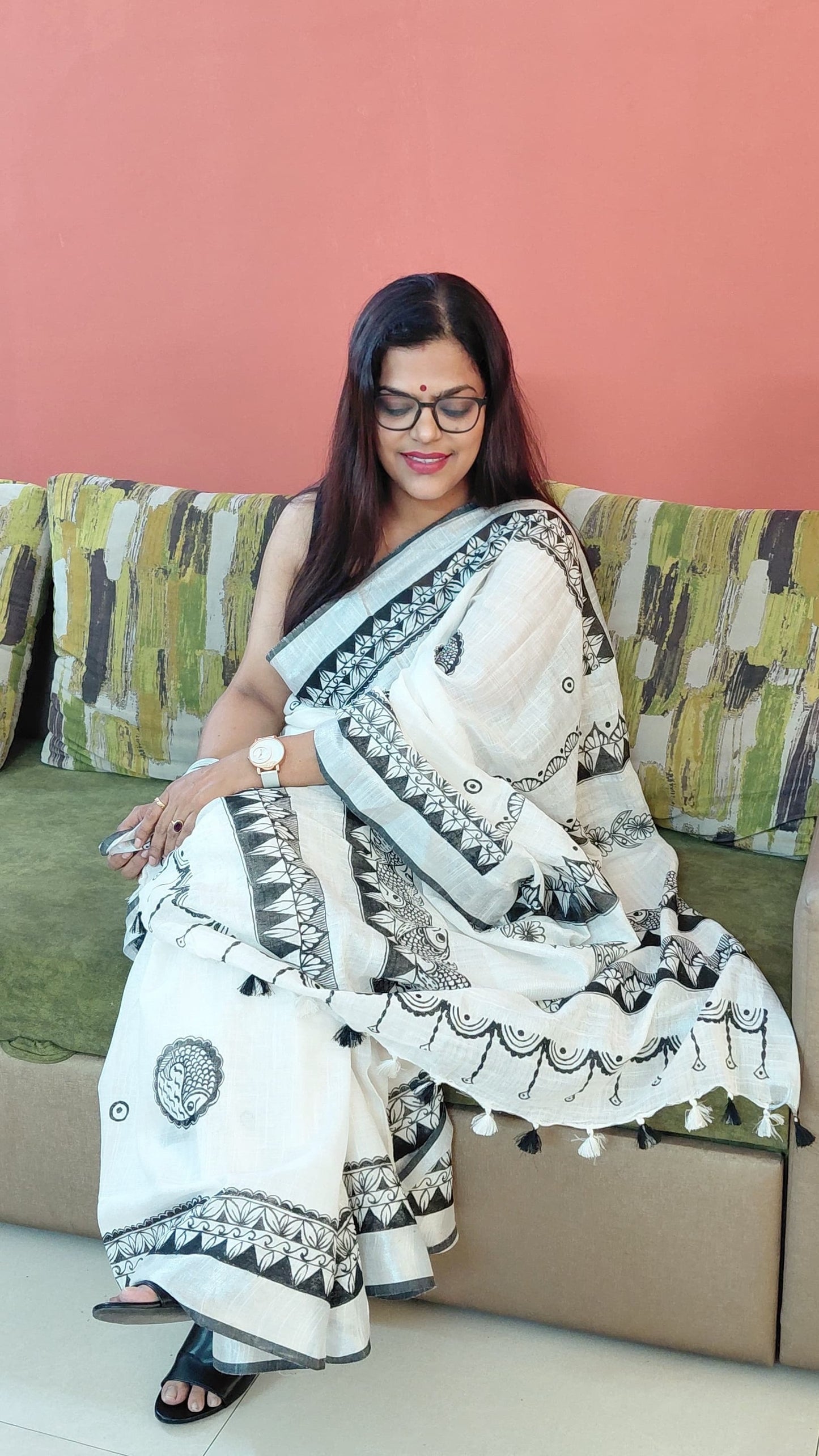 Model wearing Madhubani saree with fish motif border