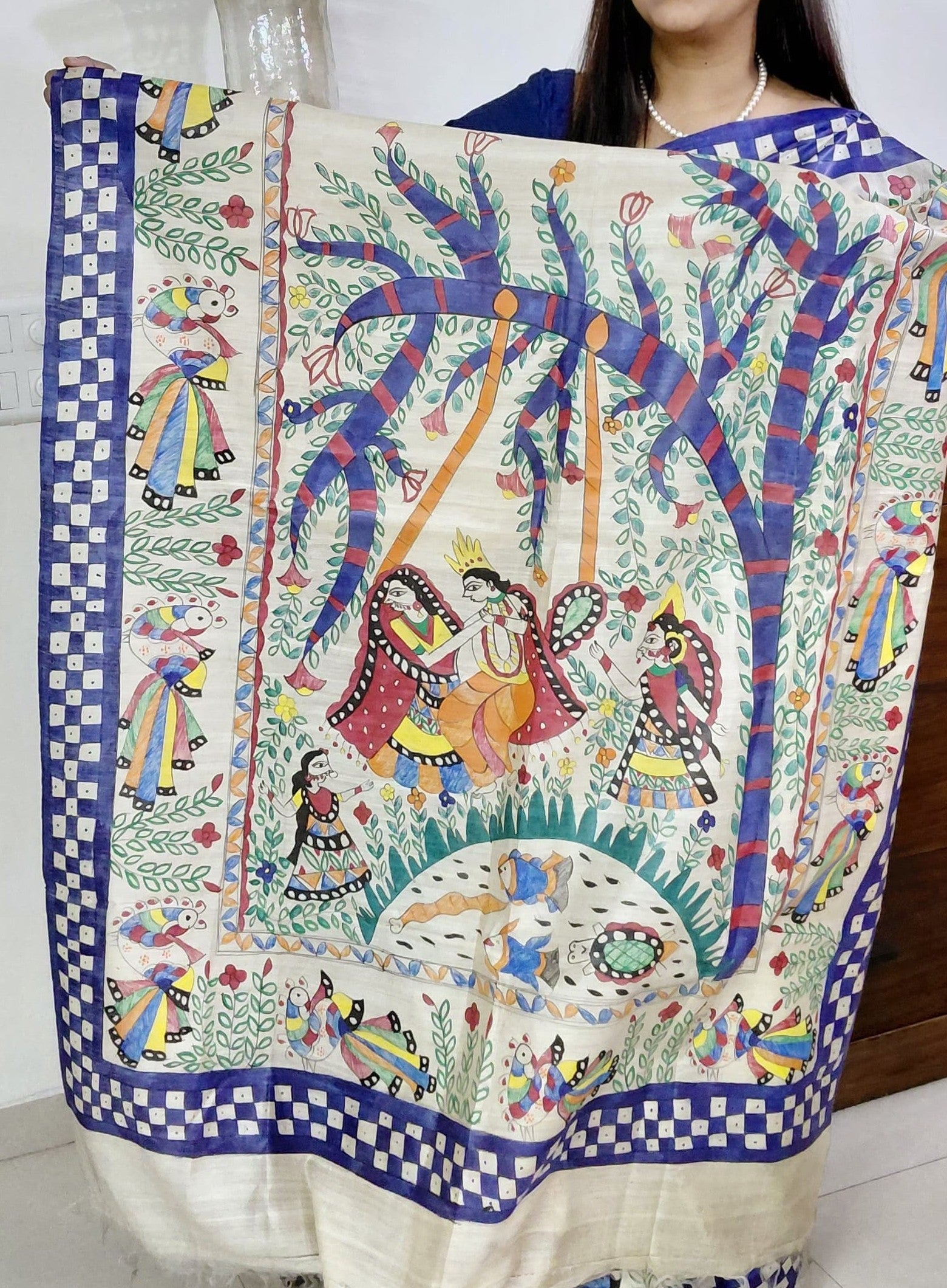 Artistic pallu spread with Radha Krishna and nature motifs in madhubani painting