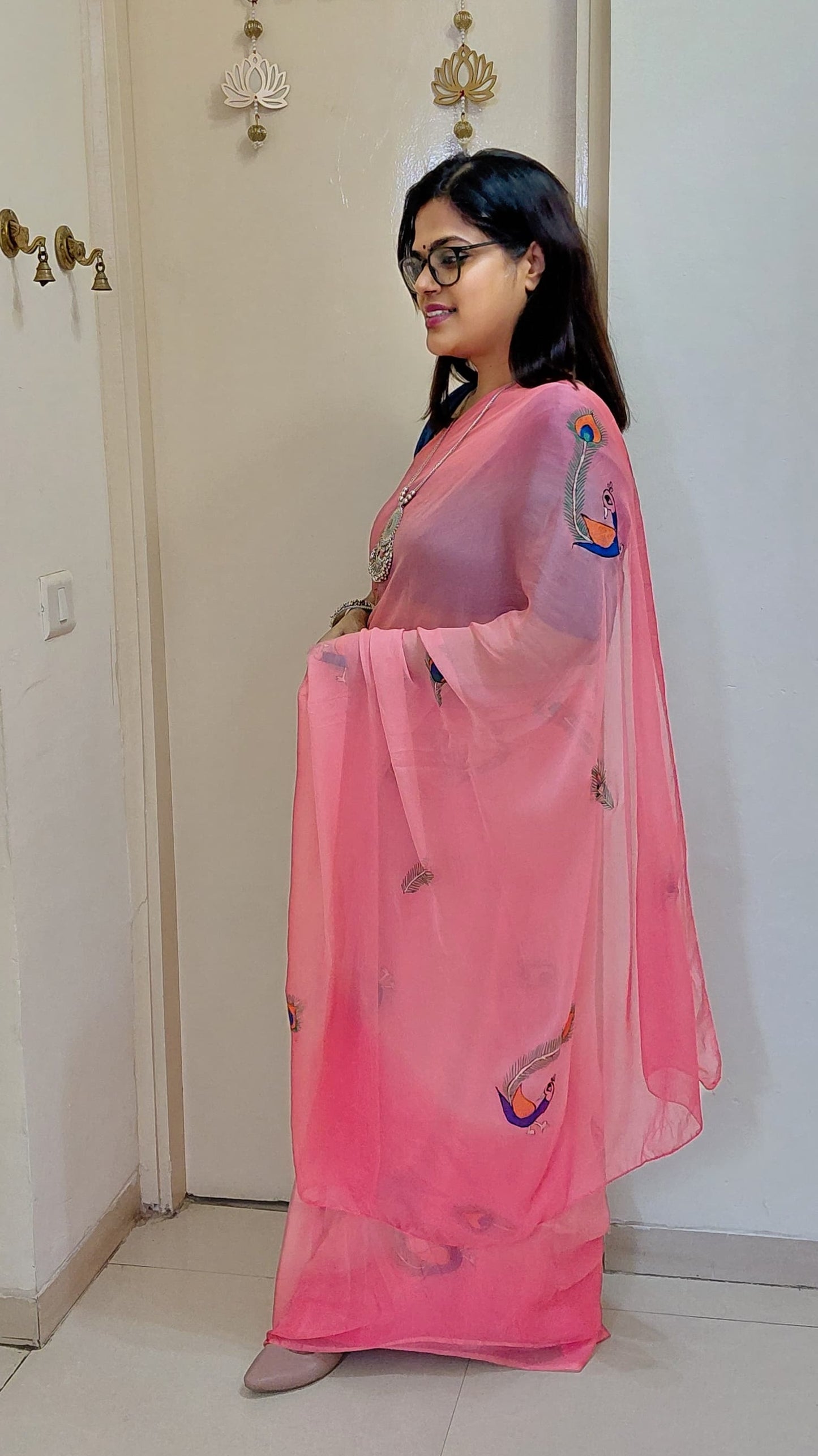 Side profile showcasing delicate Peacock Feather artwork on Candy Pink Chiffon Saree