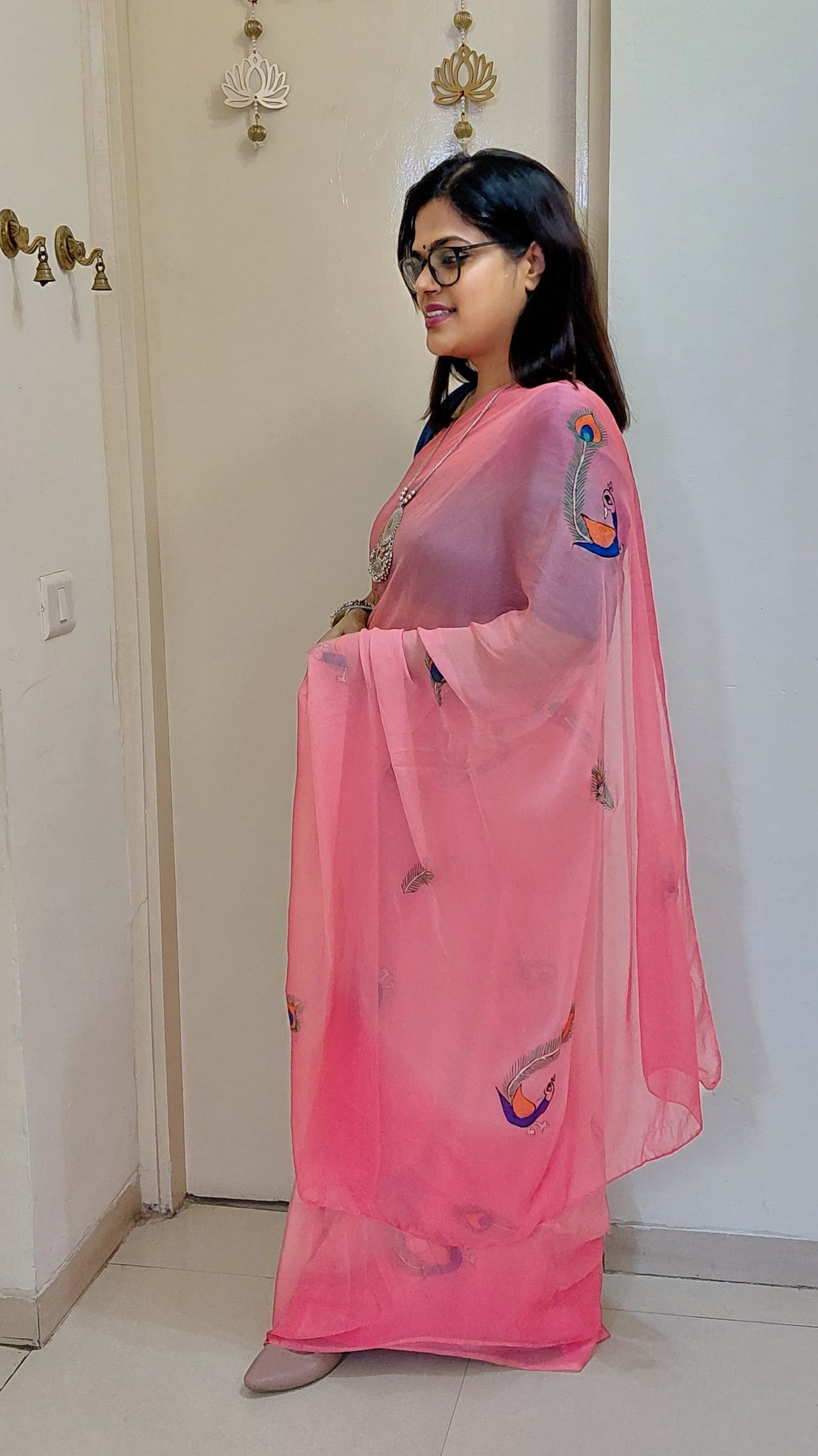 Side profile showcasing delicate Peacock Feather artwork on Candy Pink Chiffon Saree