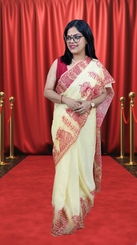 Woman wearing Soft Butter Yellow Pure Chiffon Madhubani hand-painted kohbar theme saree
