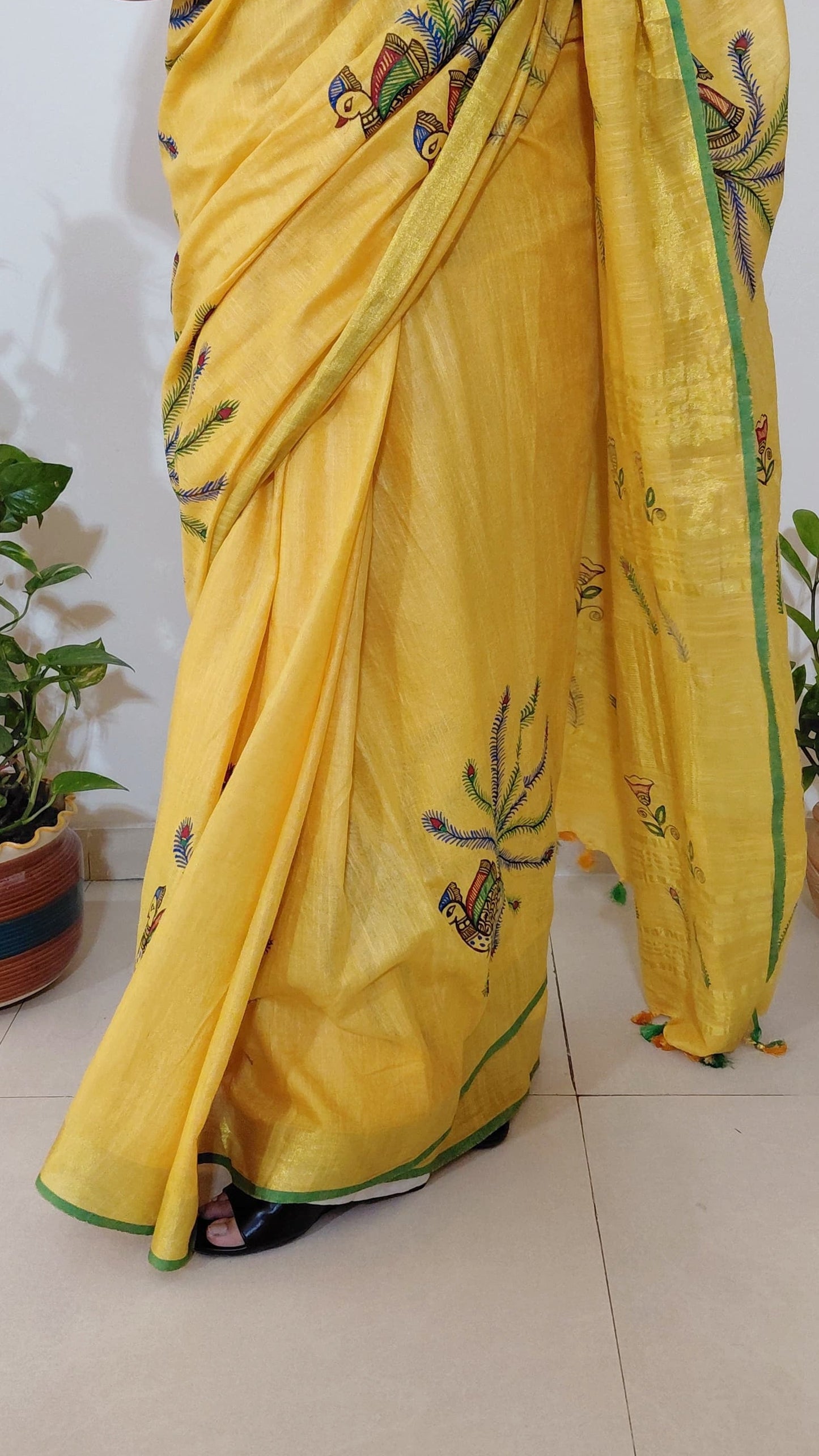 Close-up of peacock motif and linen texture on saree