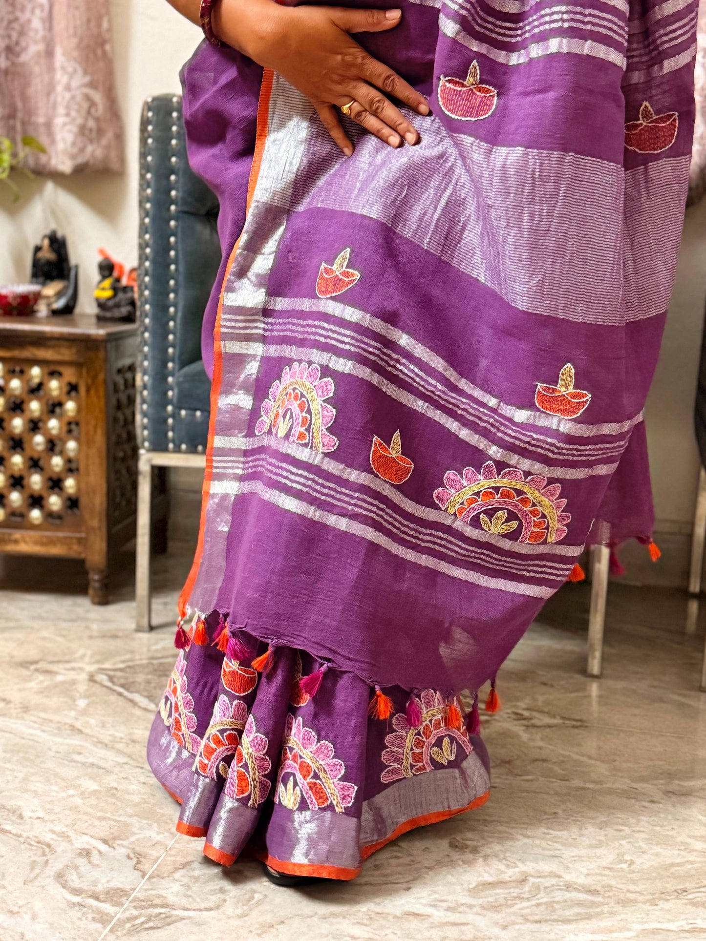 Detailed view of silver woven stripes and Sujni embroidery on linen saree