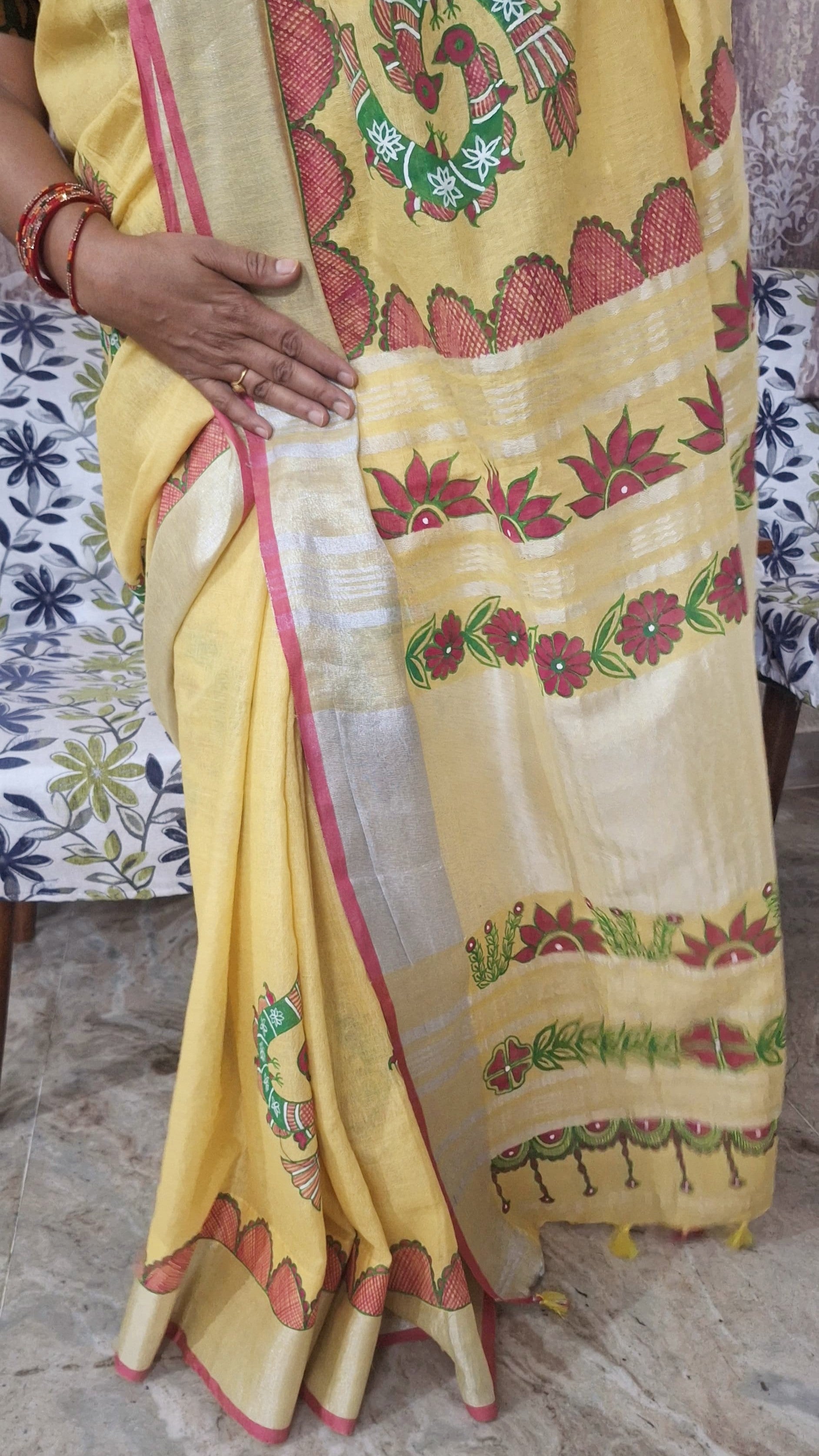 Close-up of hand-painted peacock motif on yellow linen madhubani saree